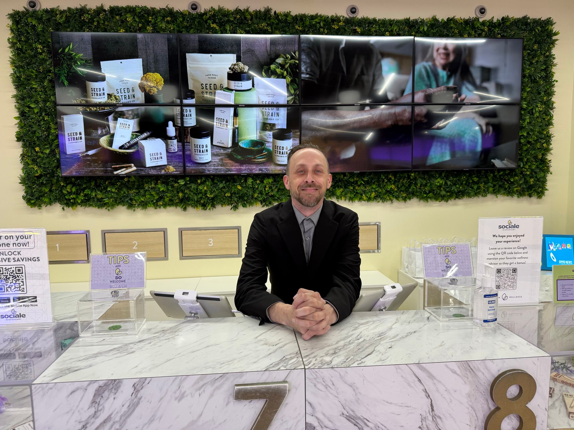 The founder behind the counter of a cannabis dispensary